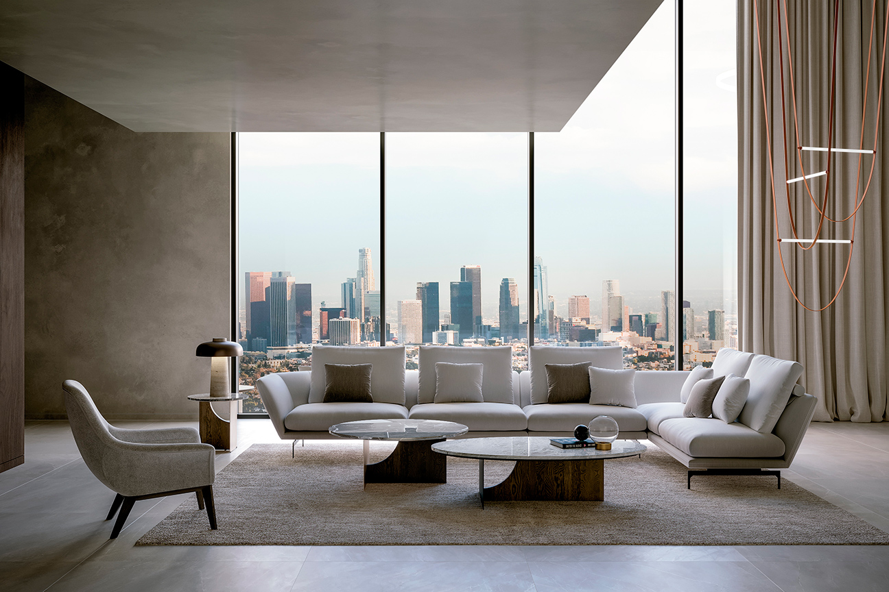 Sala de estar moderna en tonos grises con sofá modular en forma de L y originales mesas centro escultóricas.