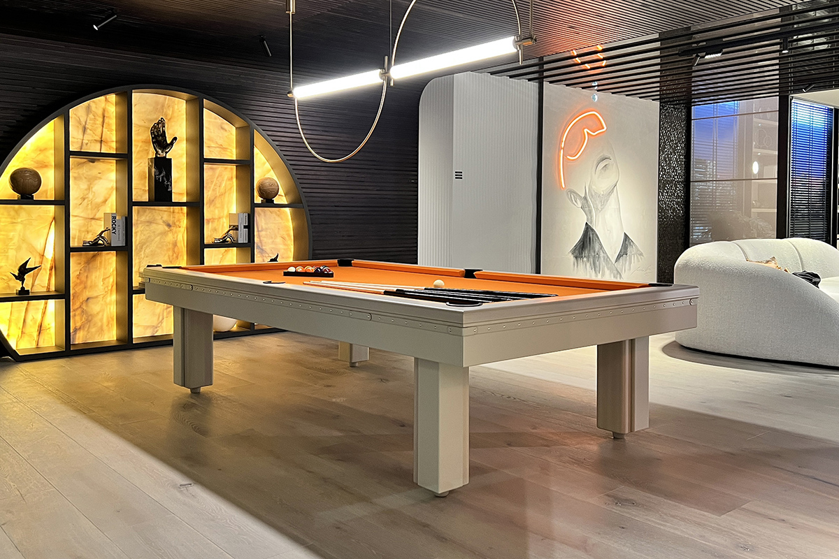 Compass modern pool table with customised white eco-leather finish and orange cloth, designed by Jacobo Ventura for luxury leisure areas.