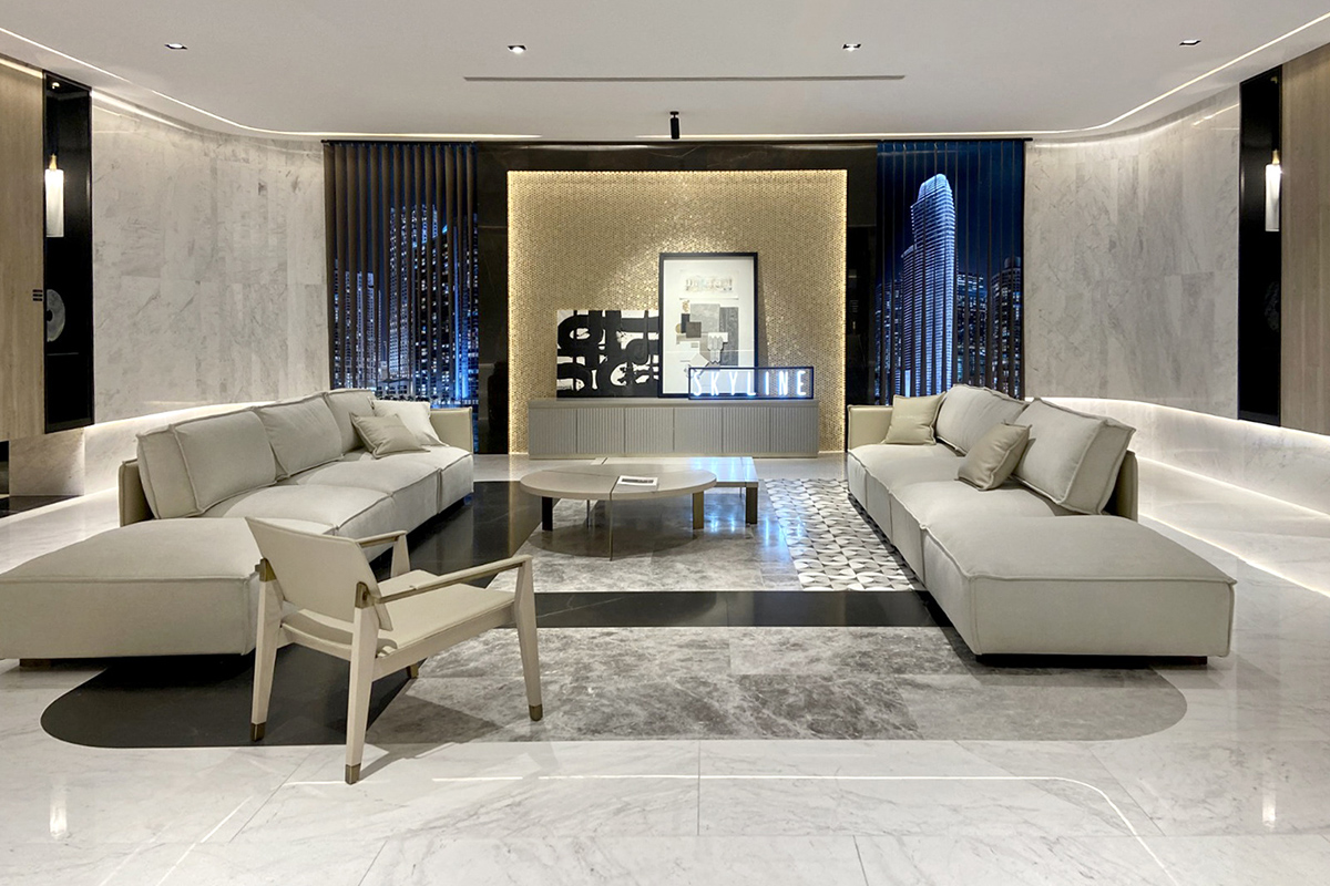 Luxury living room with marble cladding and golden tones, furnished with Tempo sofas and coffee tables.