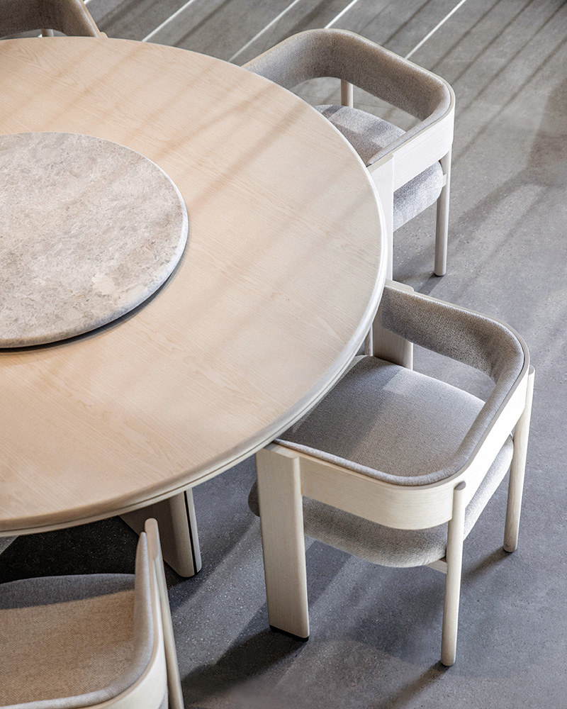 Round Decorte dining table by Francesc Rifé for Alexandra, crafted in ash wood with a marble lazy Susan, functional luxury