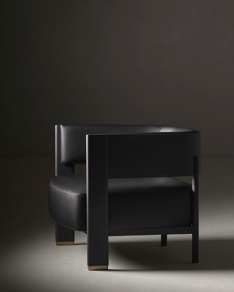 Jude armchair by Francesc Rifé for Alexandra, featuring dark ash wood and black leather, a modern design statement