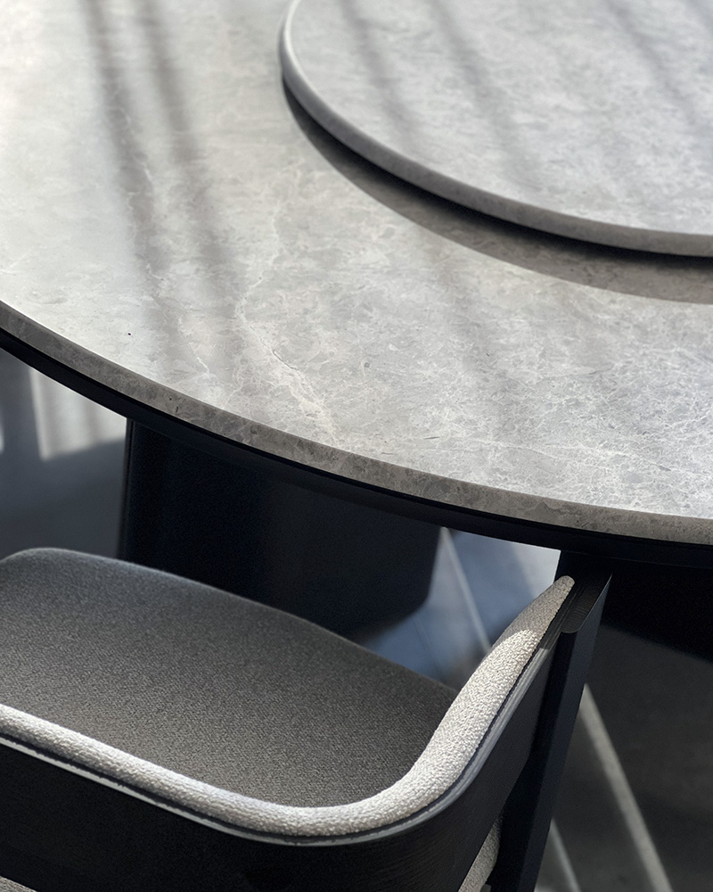 Close-up of Decorte dining table with optional lazy Susan, blending functionality and luxury