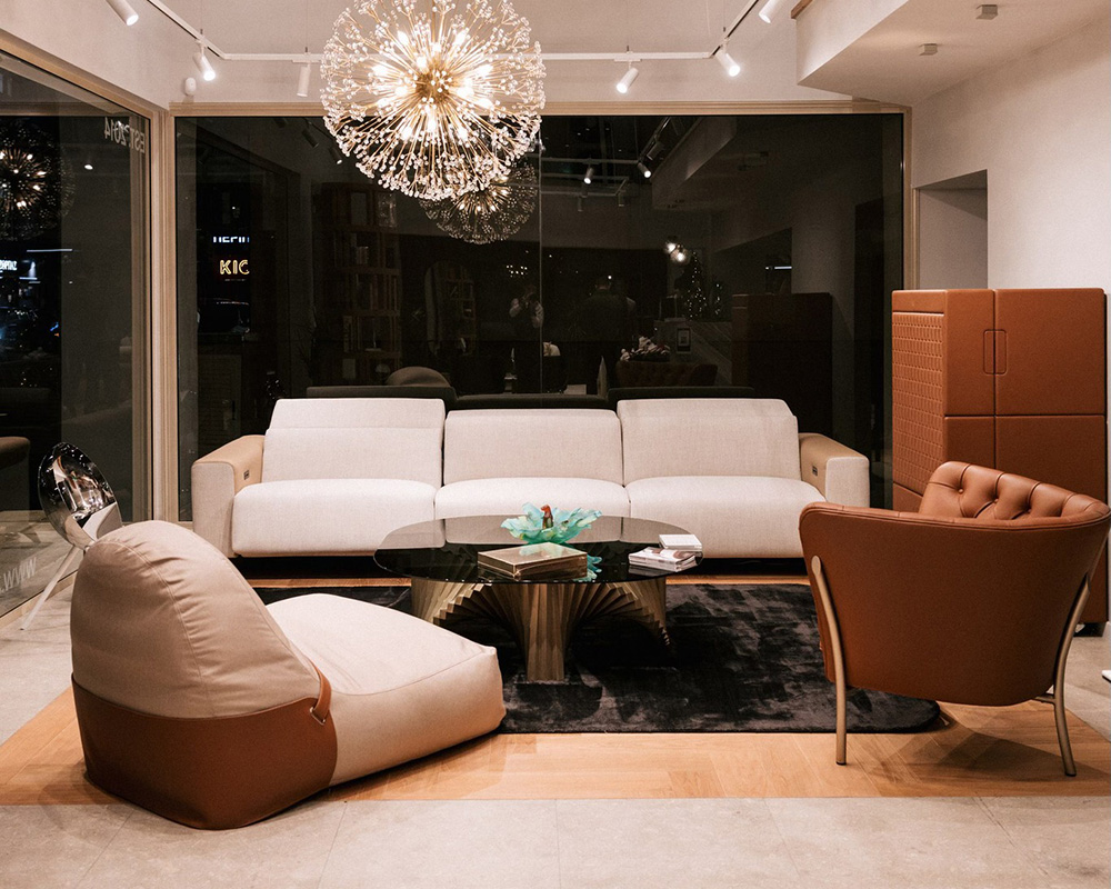 Sophisticated living room featuring the Atlanta electric recliner, Flute designer armchair, iconic Tempo table, and Nido armchair, redefining luxury and style